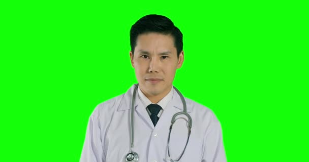 Male Doctor Showing Thumb Green Background — Stock Video