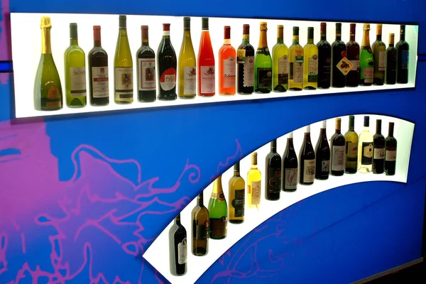 Turín, Piamonte, Italia. -10 / 26 / 2009- Feria "Wine show" fila de botellas de vinos tintos y blancos . — Foto de Stock
