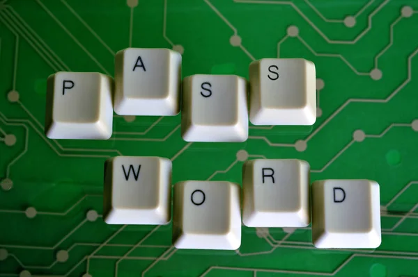 Keyboard keys form the word PASSWORD on green electric circuit in the background.