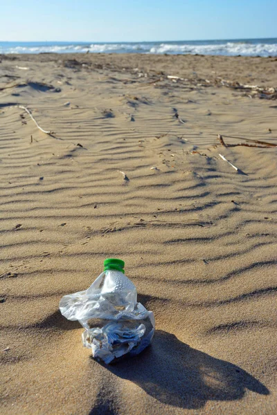 Poluição por garrafas plásticas em uma praia de areia . — Fotografia de Stock
