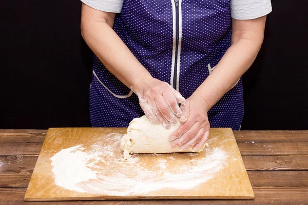 hands knead dough with hands