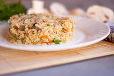 White plate with spicy pilaf with mushrooms