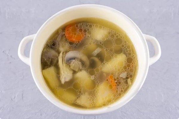 Cuenco de caldo de pollo con champiñones champiñones primer plano sobre fondo gris — Foto de Stock