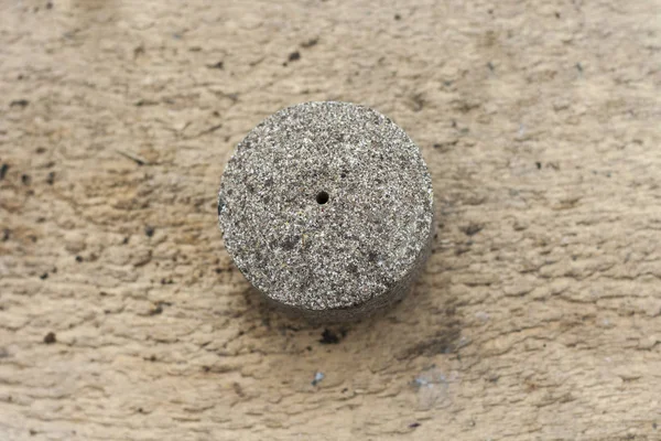 Pressed sunflower seeds into a round briquette. It is used as feed for animals, birds and fish. One of the feed ingredients. Copy space.