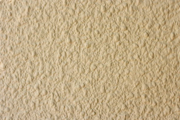ベージュの壁 毛皮のコートのためのパリの石膏 多孔質壁表面にエンボス加工 ファサードの壁の装飾石膏 テクスチャ — ストック写真