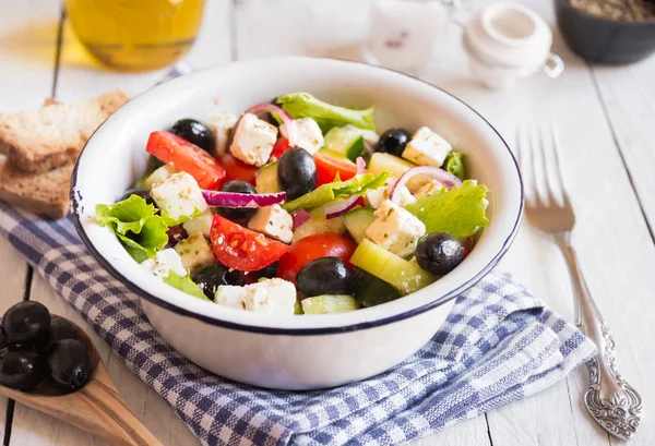 Смачний грецький салат з сиром фета та оливками у білій мисці — стокове фото
