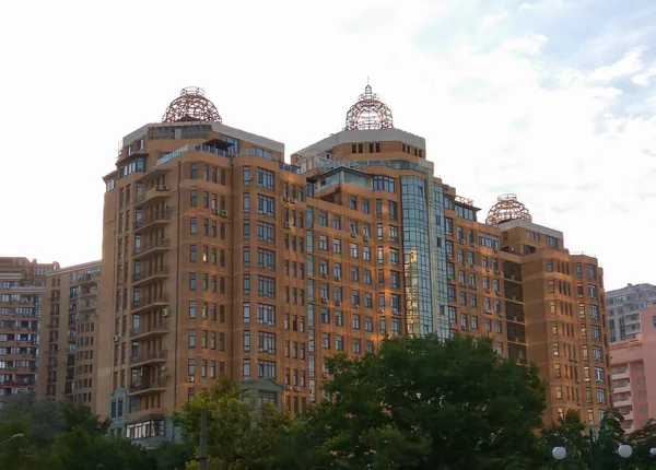 Un inusual edificio rosa de varios pisos o casa con vidrio azul. Patrón geométrico de un edificio rosa de varios pisos . — Foto de Stock