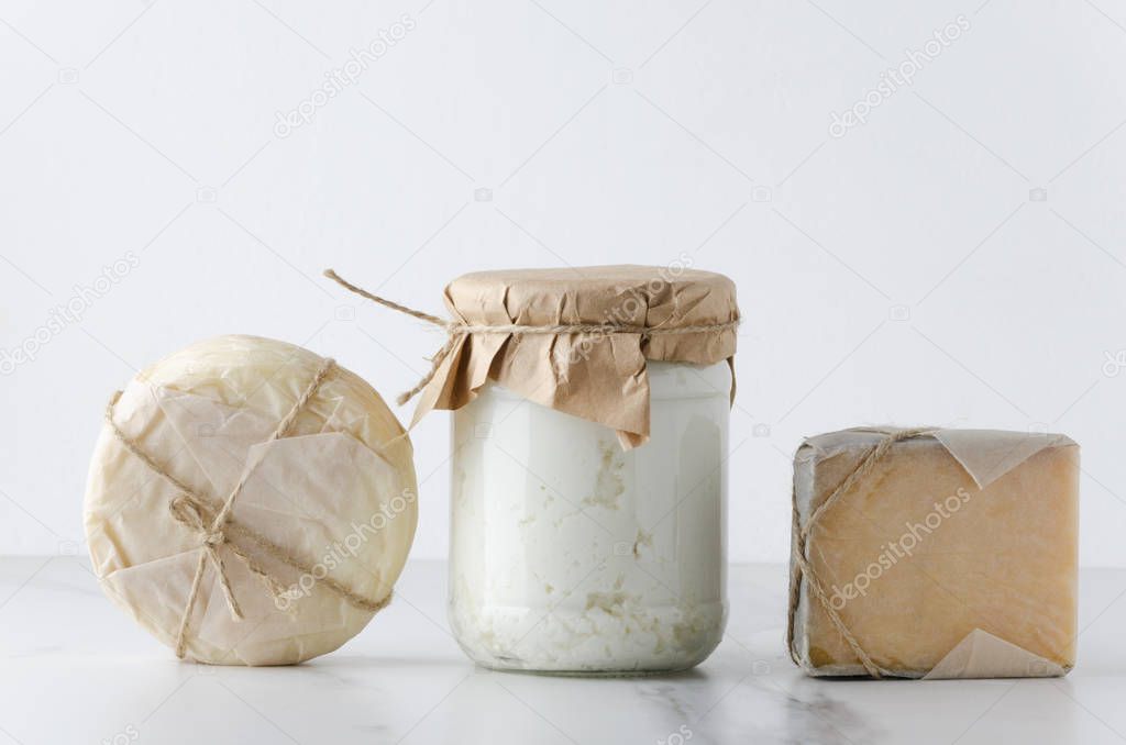 Row of assortment of cheese on table.Gouda, ricotta,provolone.Traditional  tasty cheese against white background