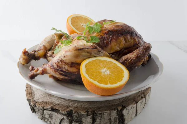 Cooked chicken with fruits,parsley on wooden cutting board.Rustic style.