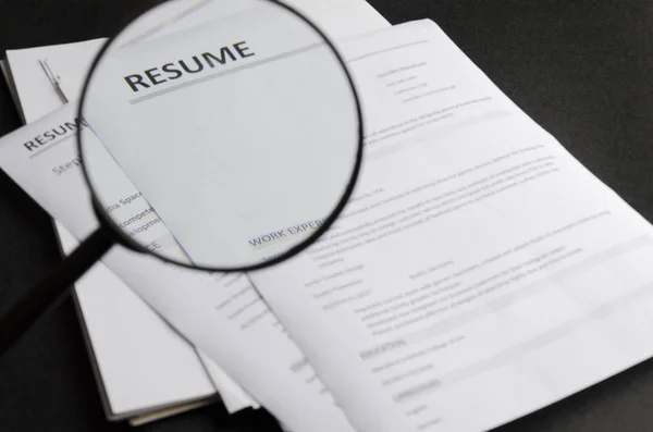 Closeup Magnifier Looking Magnifier While Reviewing New Candidate Resume Applictaions — Stock Photo, Image