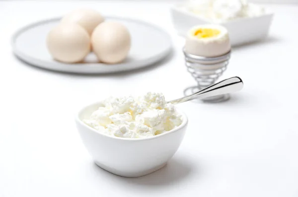 Healthy breakfast full of protein and calcium.Cottage cheese, eggs.White and bright colors