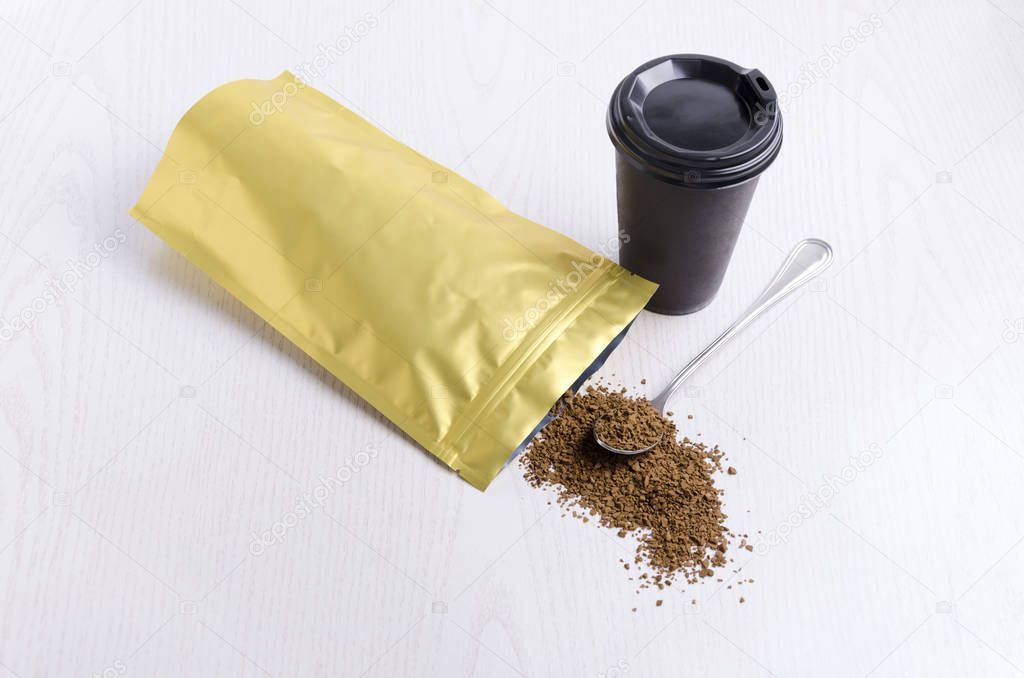 Instant coffee, black paper cup and coffee packaging on white surface