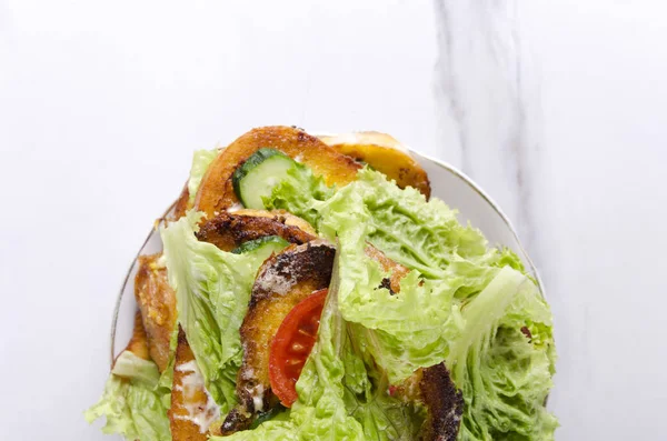 Fast cooked toasts with vegetable, top view and copy space.Pile of toasts on plate, marble kitchen table