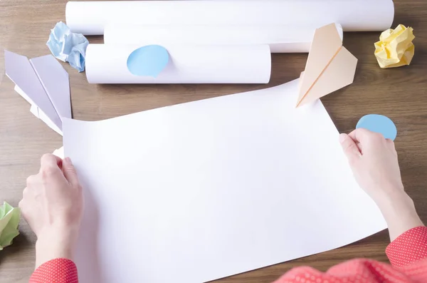 Woman holding empty paper, crumpled paper, paper airplanes as a symbol of startup.Concept of making plan of startup