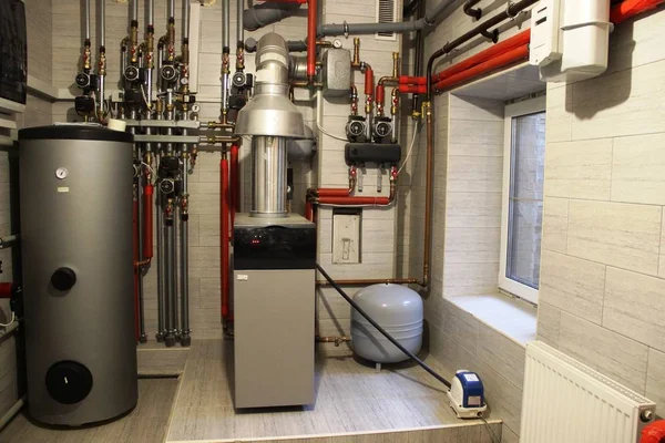 boiler, water heater, expansion tank and other pipes. house boiler room with a heating system.