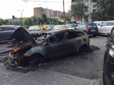 a burned-out car in a city parking in Moscow. burnt car clipart
