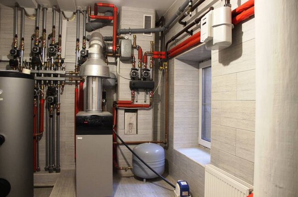 comfort House. boiler, water heater, expansion tank and other pipes. modern independent heating system in boiler room.