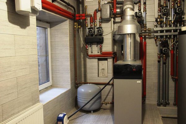 house boiler room with a heating system. modern independent heating system in boiler room, selective focus