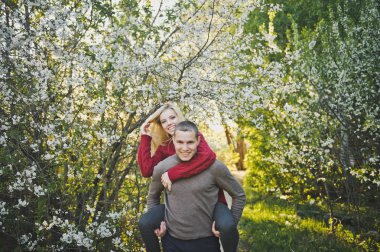 Kız neşeyle adam çiçek açan bir bahçe zemin üzerine palan.