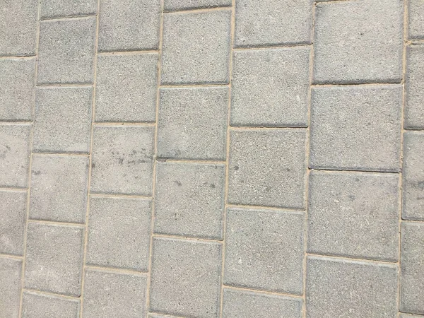 Worn footpath walk textured , gray brick block floor. Grey brown rectangle shape clay tile floor pattern, brick pavement background. — Stock Photo, Image