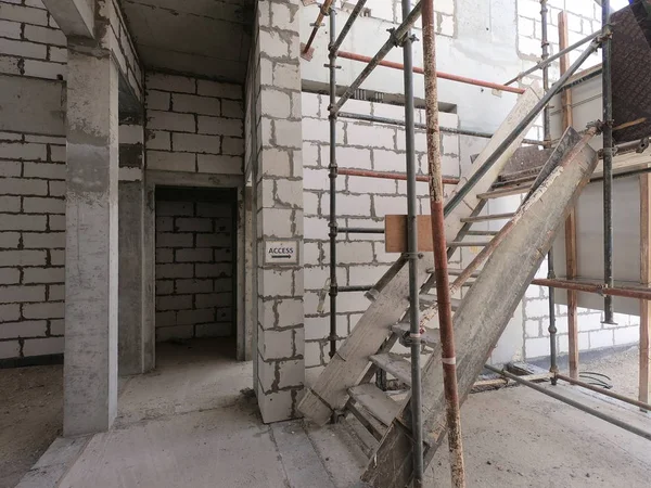 Escada temporária subindo em um canteiro de obras de uma casa moderna em um terreno. Nenhuma pessoa presente . — Fotografia de Stock