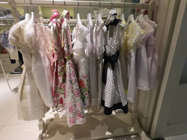 Dubai UAE - July 2019: A row of children clothes hanging on hangers. Children clothing inside a shop. A view of colourful kid dresses and frocks hanging on the cloth rack in the shop. — Stock Photo, Image