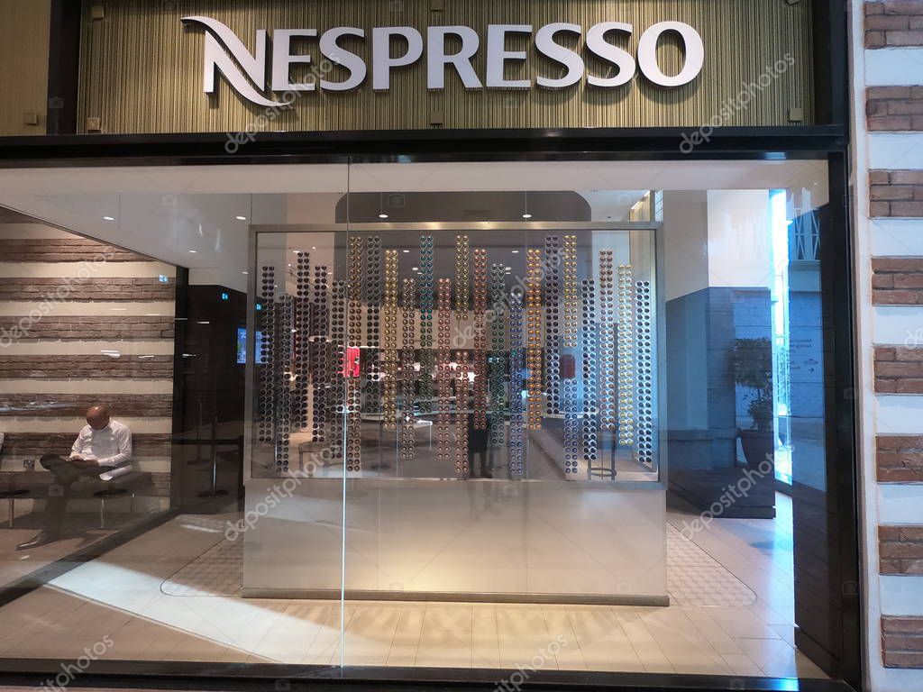 Dubai UAE - July 2019: Nespresso shop in the city center mall. Nespresso coffee shop window. Signage and store window of famous coffee machine brand's store in Dubai.