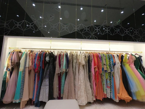 Dubai UAE - August 2019: Department of dresses in the women's clothing store. A lot of female Evening Gowns, dresses displayed for sale on hangers in a boutique clothing shop. — Stock Photo, Image