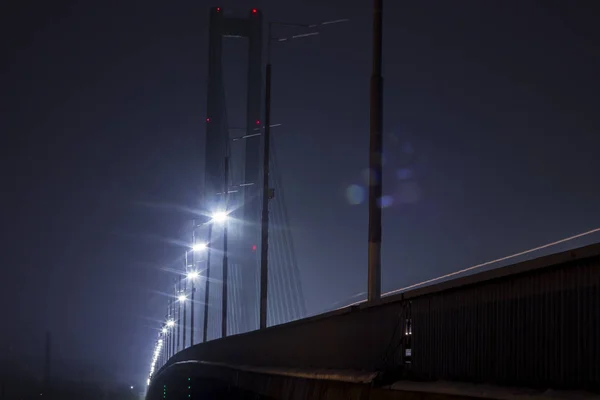night bridge with lights on it