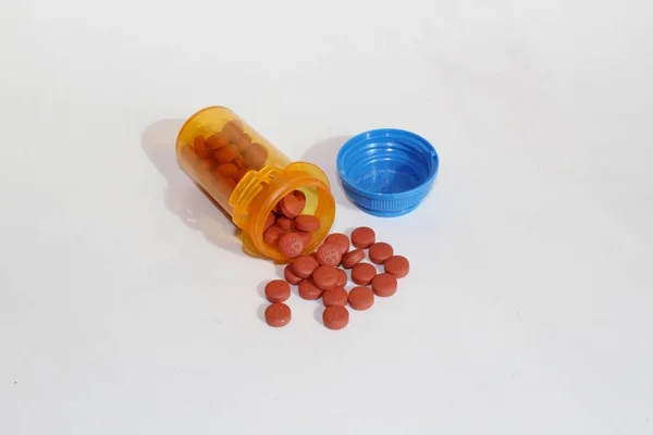 Pills spilling out of prescription bottle