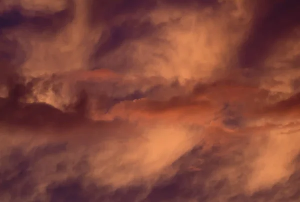 Dramatic purple cloud formations at sunset