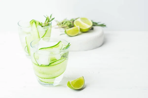 Fresh cucumber drink sprig of rosemary on a white background. Summer refreshing detox. Selective focus. — Stock Photo, Image