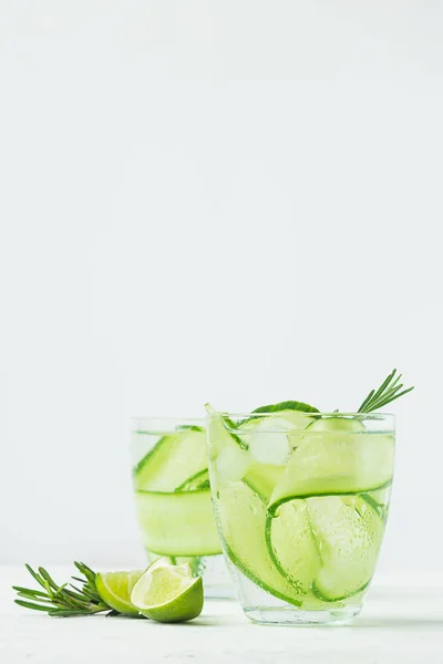 Fresh cucumber drink sprig of rosemary on a white background. Summer refreshing detox. Selective focus. — Stock Photo, Image