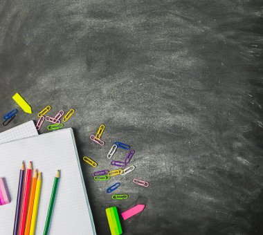 Eğitim malzemeleri defterkalemkalem bir tebeşir tahtası arka plan karşı kalem. Kavram okula geri döndü. Düz düzen