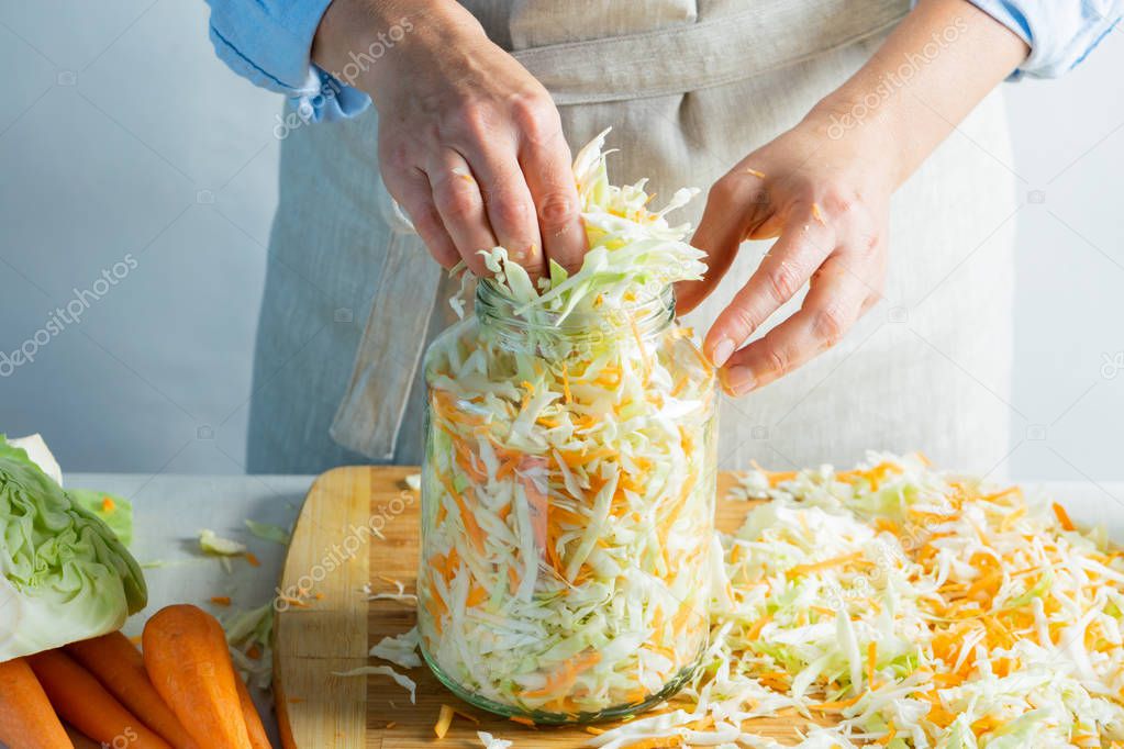 The preparation process fermentation preservation Sauerkraut on a light background. Natural rustic style. Canned food