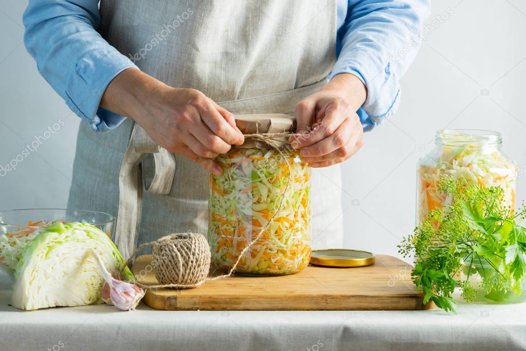 The preparation process fermentation preservation Sauerkraut on a light background. Natural rustic style. Canned food