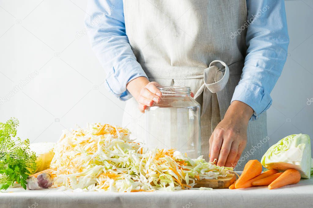 The preparation process fermentation preservation Sauerkraut on a light background. Natural rustic style. Canned food