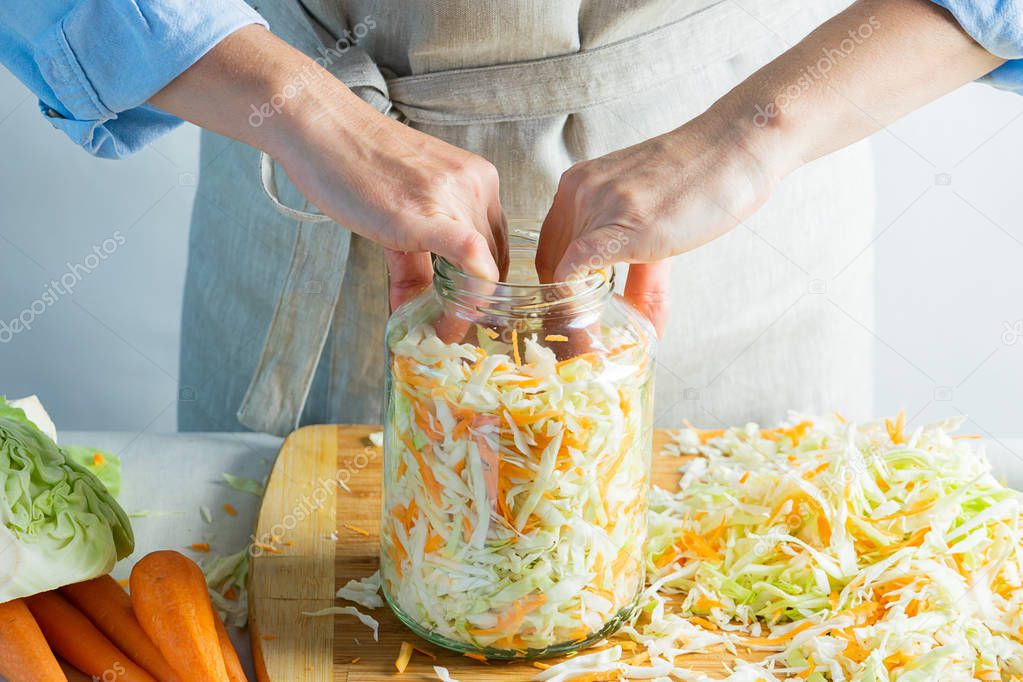 The preparation process fermentation preservation Sauerkraut on a light background. Natural rustic style. Canned food