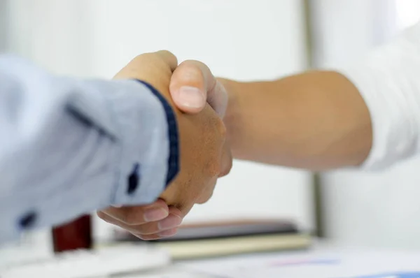 Close-up  of business partners shaking hands an