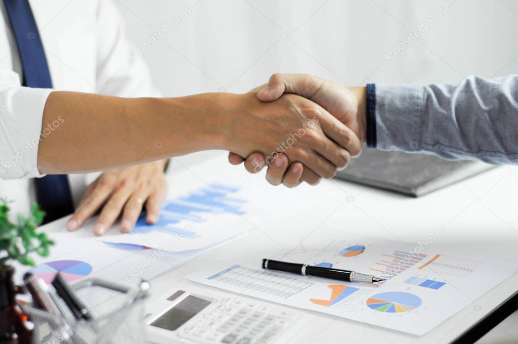 Close-up  of business partners shaking hands an