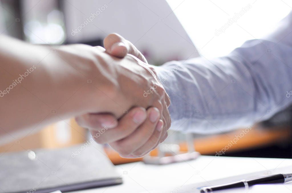 Close-up  of business partners shaking hands an