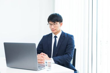 Masada jestleri olan iş adamları, çeşitli şekillerde çalışırlar, otururlar, çalışırlar, mutlu olurlar, iş yerinde oturup düşünürler.