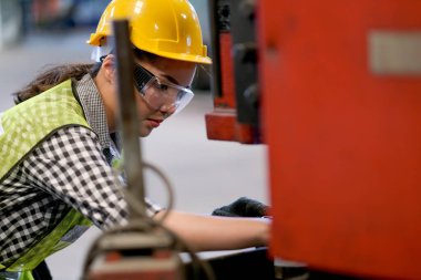 Asyalı işçi ya da teknisyen kadın fabrika işyerindeki makine sorununu çözer ve yönetici tarafından atanır. İyi sistem kavramı ve daha iyi endüstriyel işletmeler için yönetici desteği.
