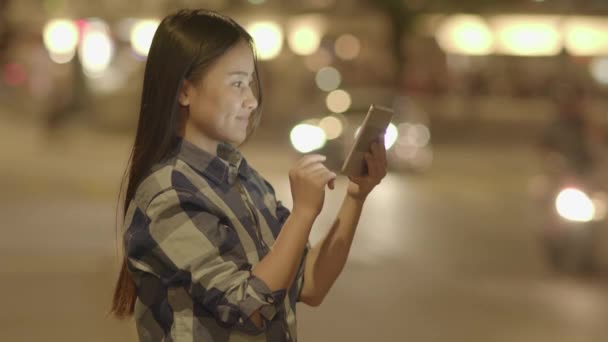 Genç Asyalı Kadın Geceleri Yol Kenarında Tablet Kullanıyor — Stok video