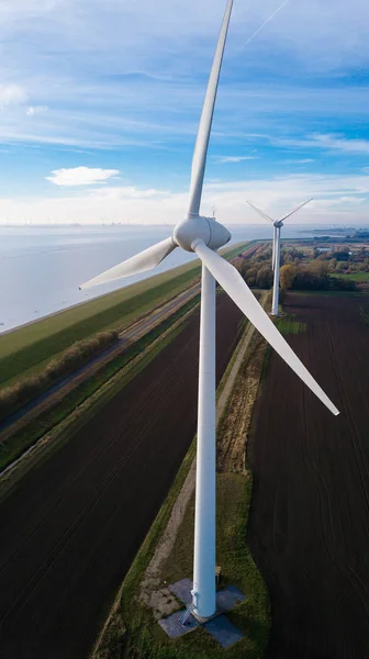 Wind turbine from aerial view. Close to the turbine. Sustainable development, environment friendly. Wind mills during bright summer day. Windmill. Agricultural fields on a summer day. — Stock Photo, Image