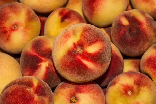 Peach Background. Texture background of sweet red ripe peaches. Ripe peaches close-up.