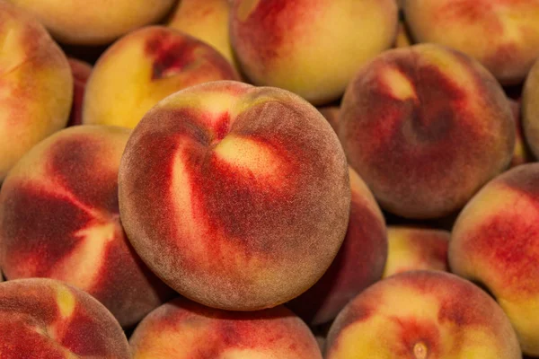 Peach Background. Texture background of sweet red ripe peaches. Ripe peaches close-up.