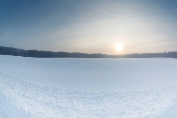 Winter landscape at sunrise with snow field