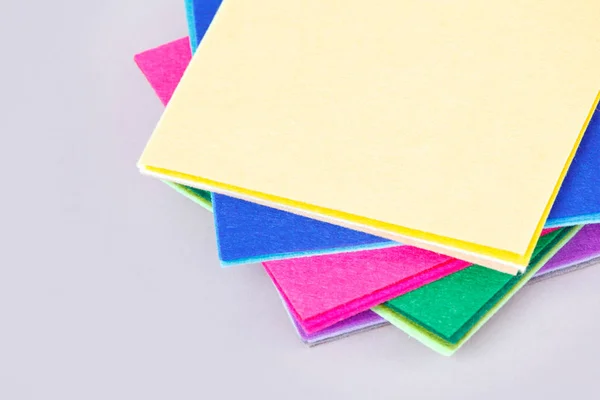 a set of colored sheets of felt, rainbow colors