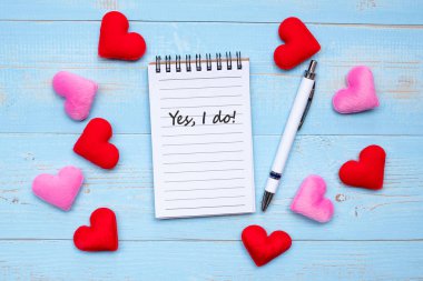 I LOVE YOU word on note book and pen with red and pink heart shape decoration on blue wooden table background. Love Wedding Romantic and Happy Valentine s day holiday concept
